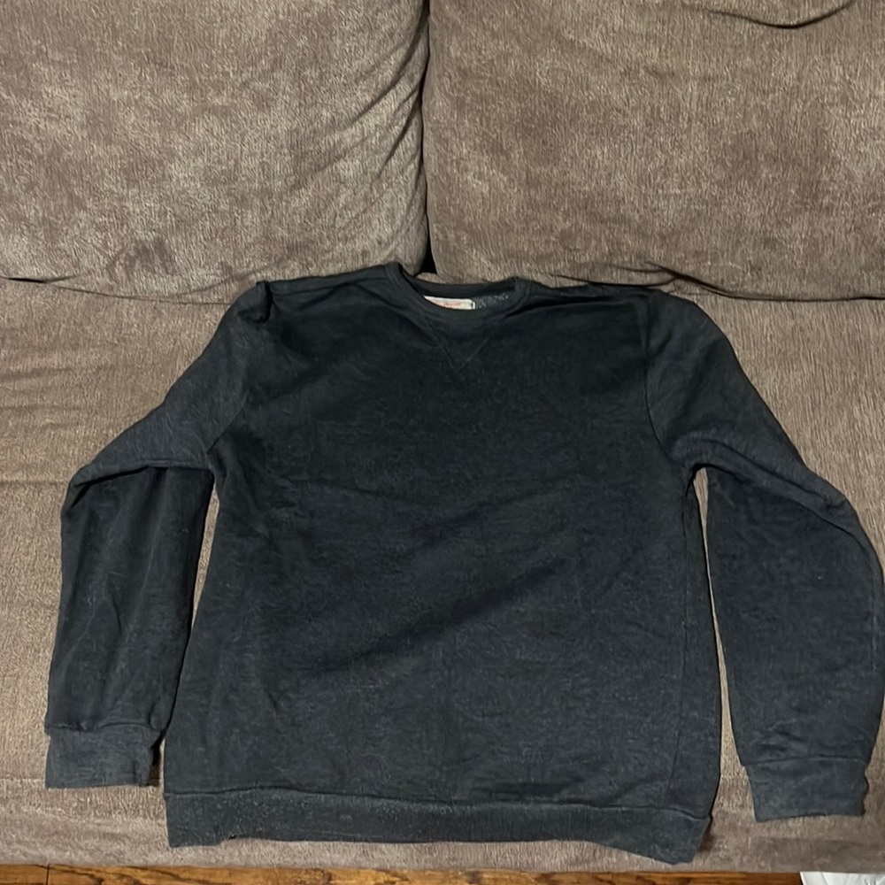Dark grey crew neck sweater.